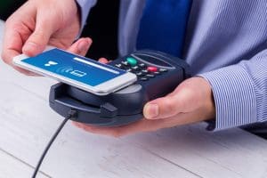 A man processing his payment via credit card terminal